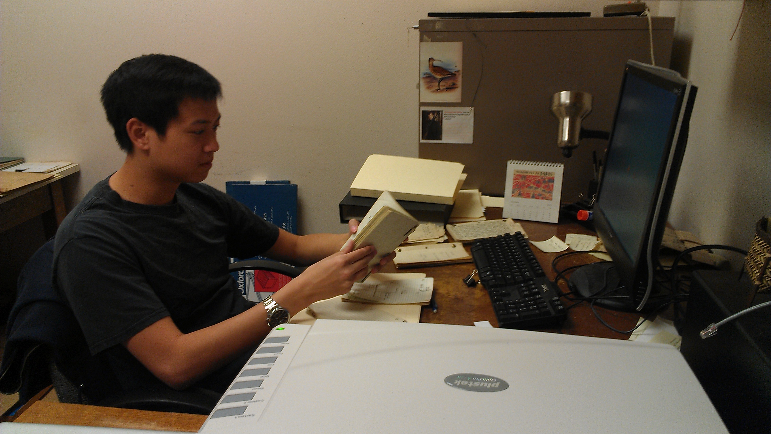 Darren Lu working through Alden H. Miller's papers.